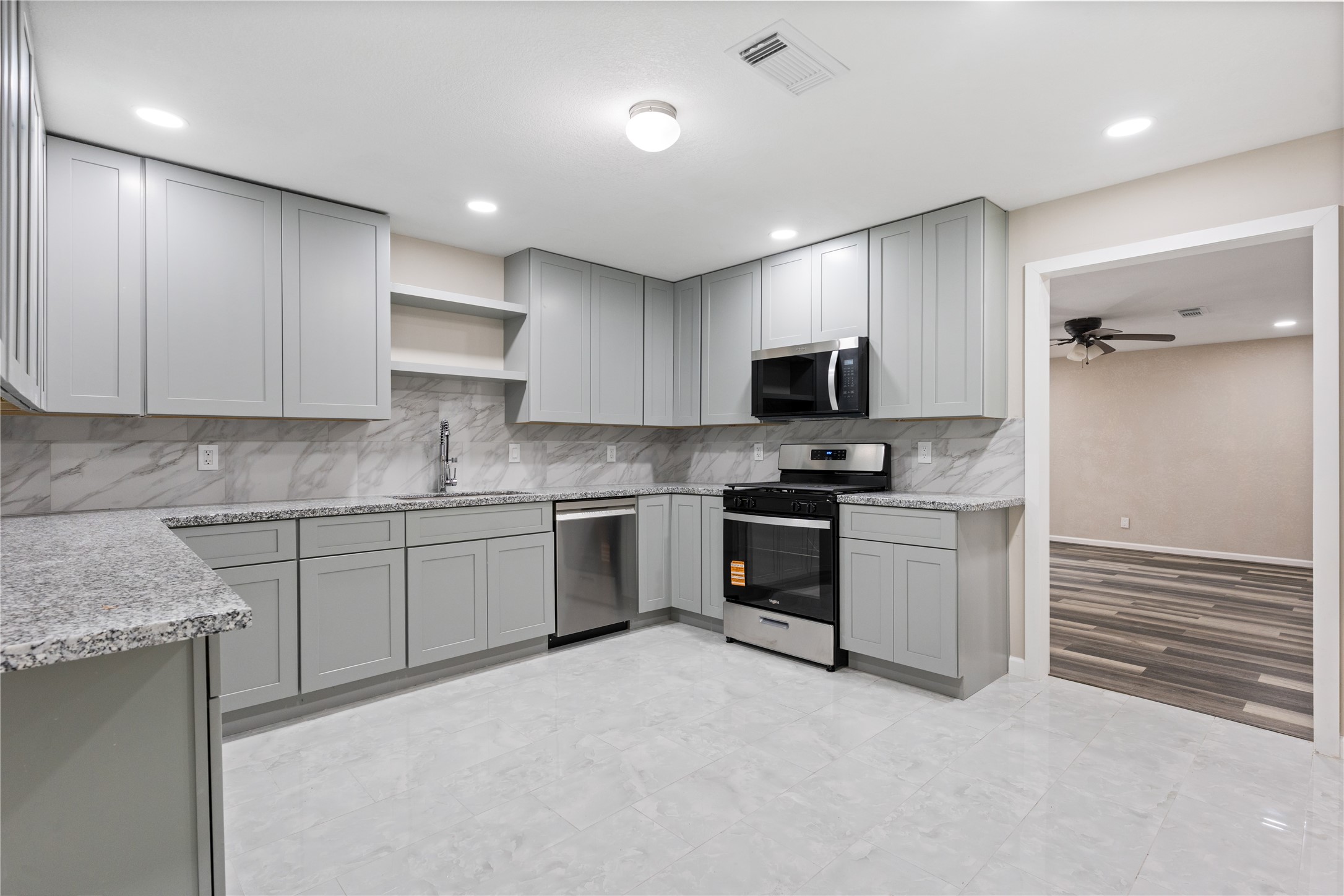 10613 Chadwick Street Houston, TX 77029 - Photo 14 of 30 a kitchen with granite countertop a sink and stainless steel appliances