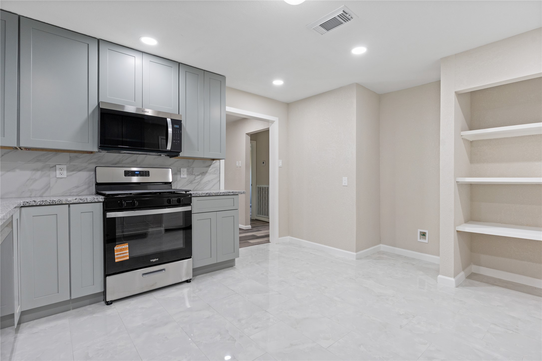 10613 Chadwick Street Houston, TX 77029 - Photo 15 of 30 a kitchen with a stove and a microwave