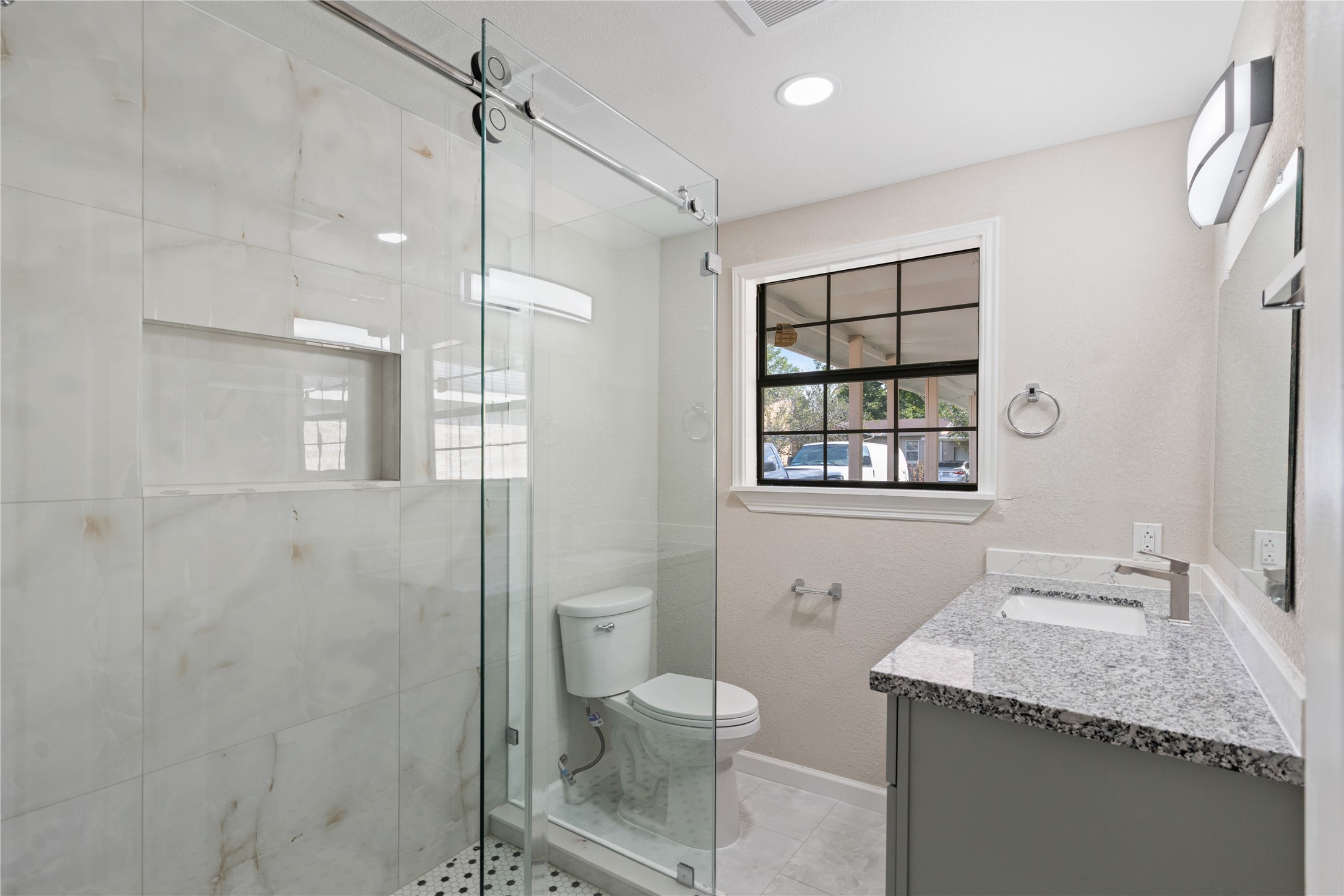 10613 Chadwick Street Houston, TX 77029 - Photo 22 of 30 a bathroom with a granite countertop sink toilet and shower