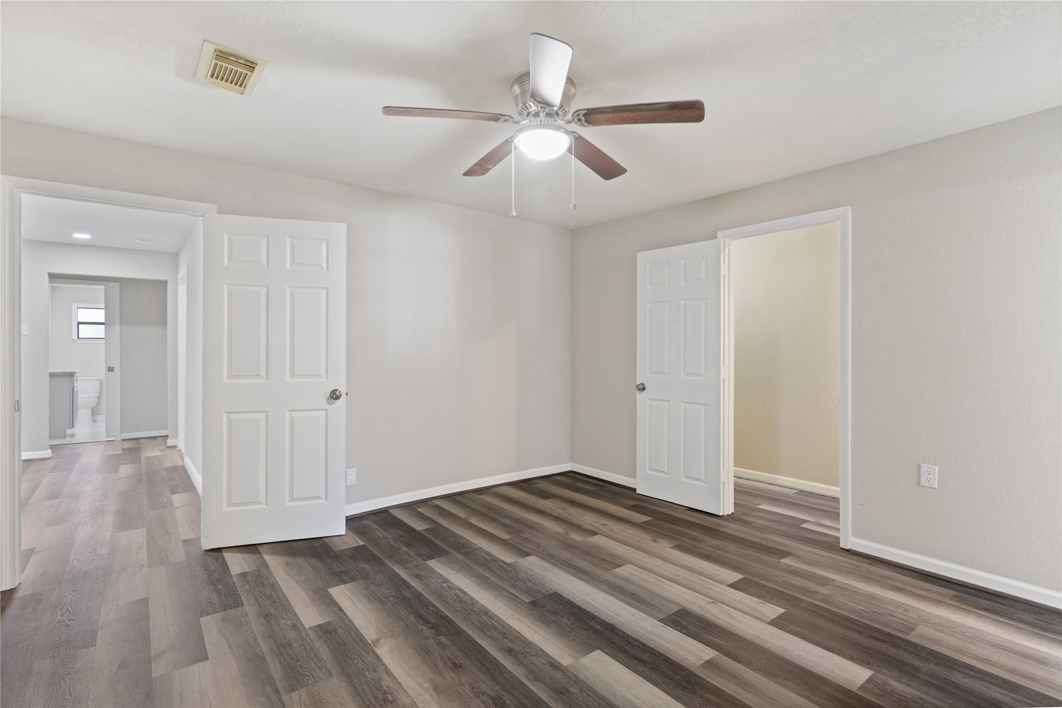 10613 Chadwick Street Houston, TX 77029 - Photo 23 of 30 a view of a livingroom with wooden floor and a ceiling fan