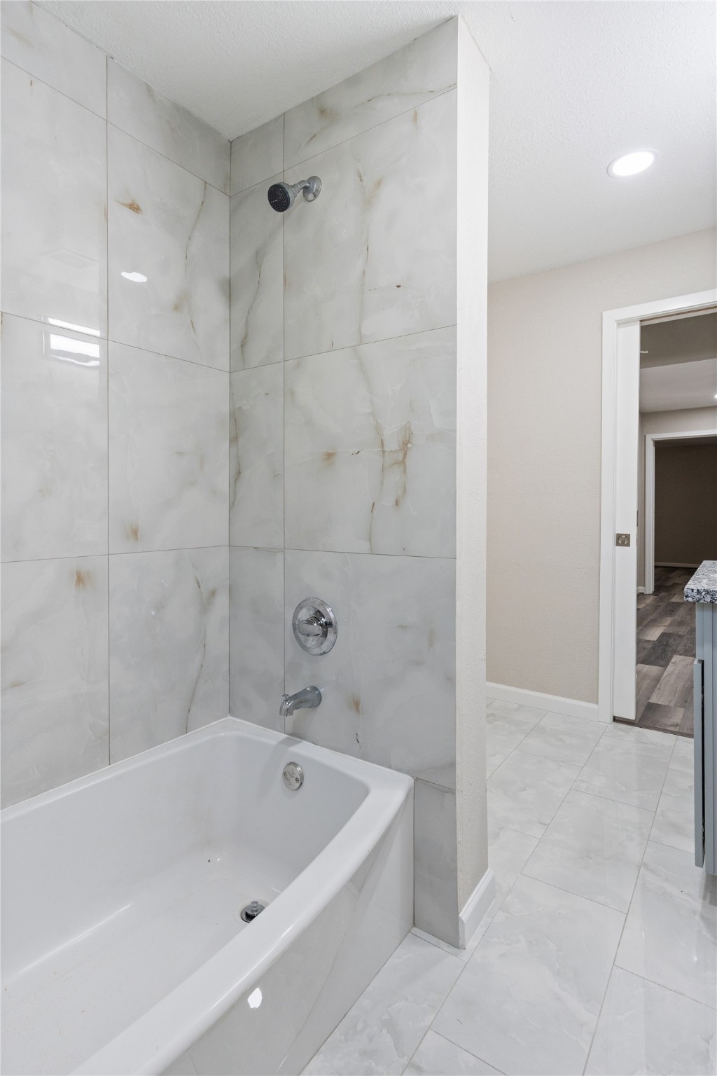 10613 Chadwick Street Houston, TX 77029 - Photo 25 of 30 a bathroom with a bathtub and a shower