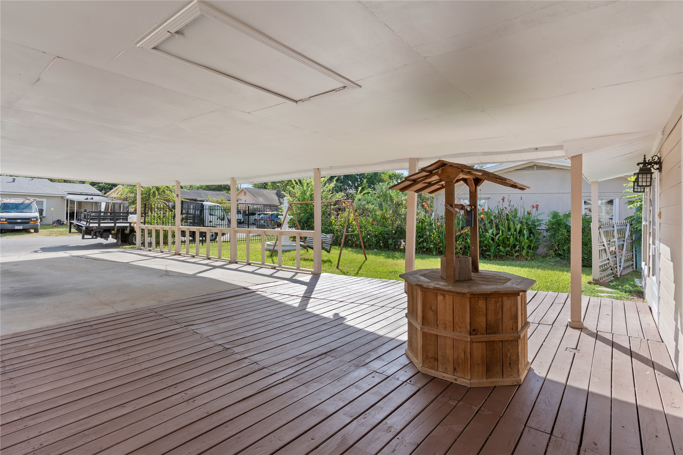 10613 Chadwick Street Houston, TX 77029 - Photo 6 of 30 a view of a patio with table and chairs wooden floor and fence