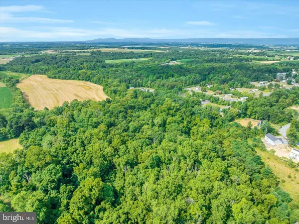 an aerial view of a house with a garden and lake view