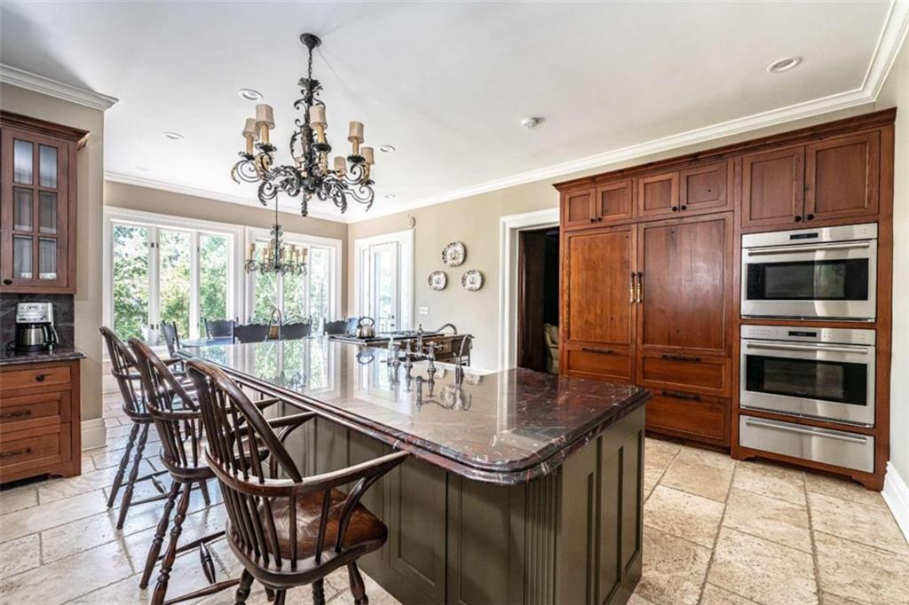 320 East 3rd Avenue Rome, GA 30161 - Photo 22 of 94 a kitchen with stainless steel appliances a dining table chairs and large windows