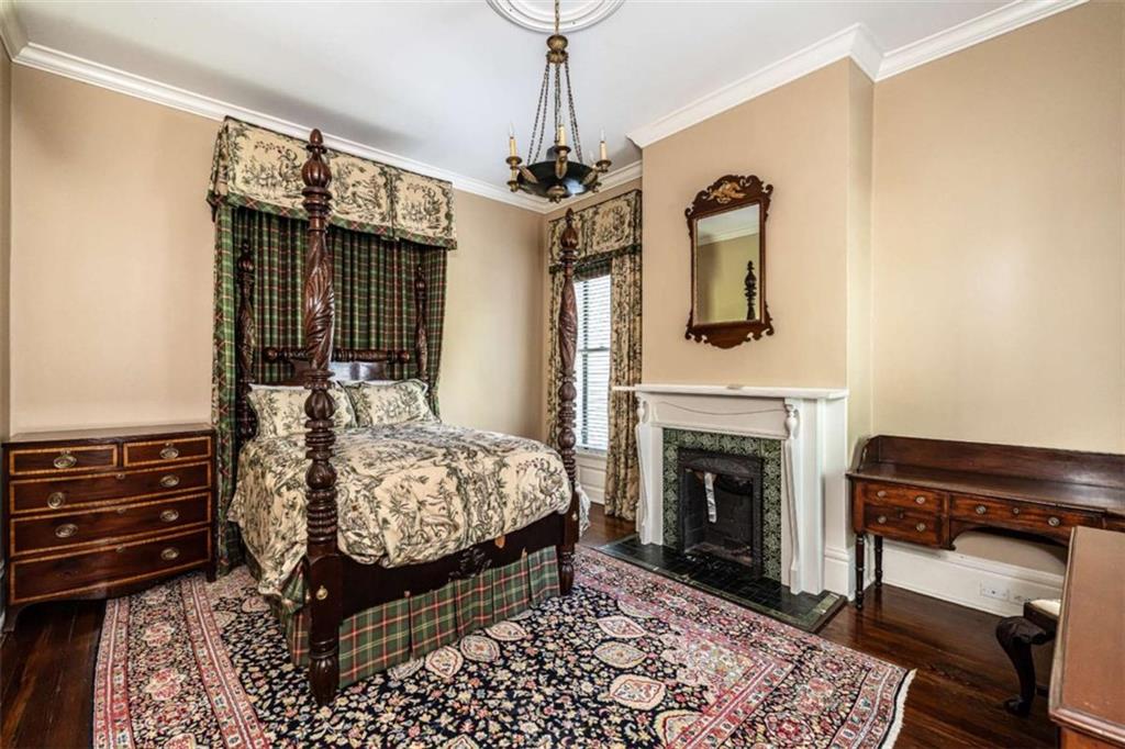 320 East 3rd Avenue Rome, GA 30161 - Photo 52 of 94 a bedroom with a bed dresser and a chandelier