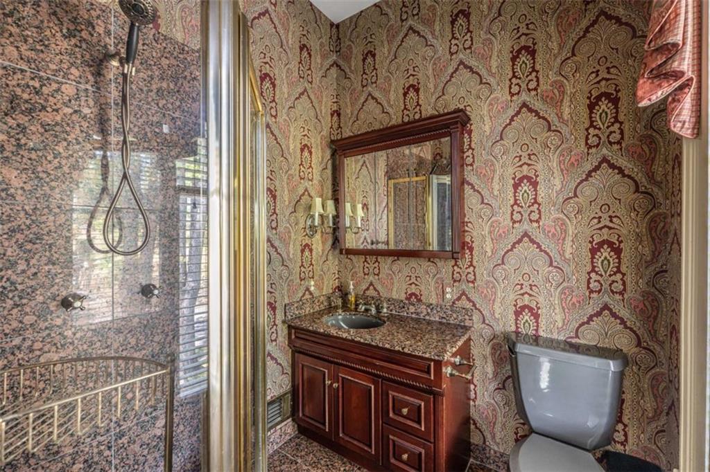 320 East 3rd Avenue Rome, GA 30161 - Photo 57 of 94 a bathroom with a granite countertop sink a toilet and shower curtain