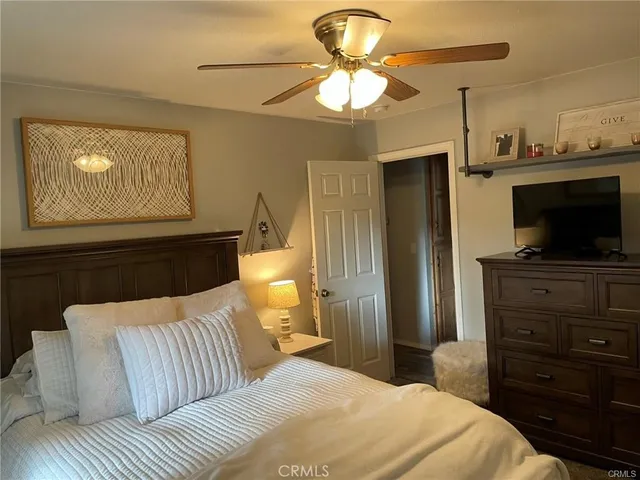 a bedroom with a bed and a television