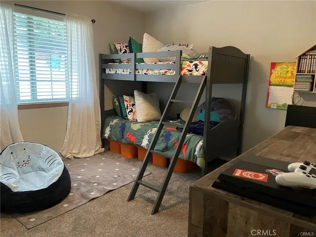 a bedroom with a bed and a flat tv screen