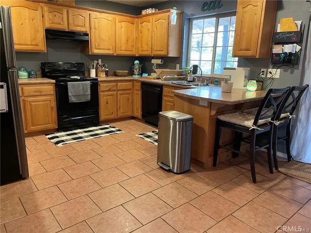 a kitchen with a sink a stove and a refrigerator