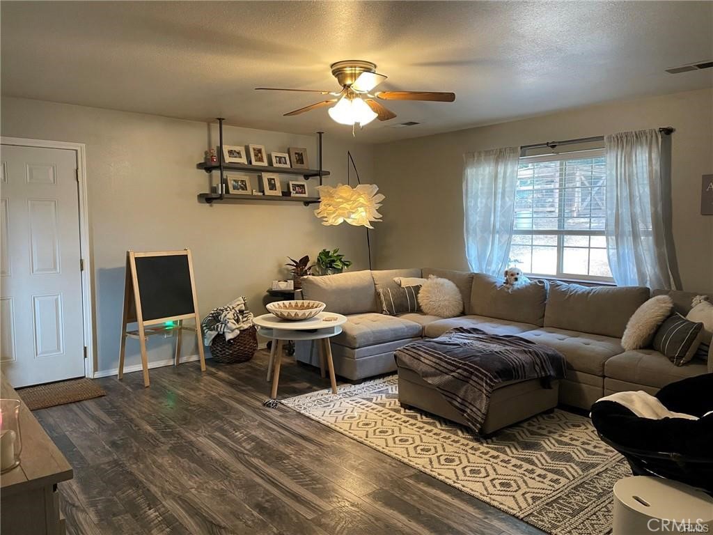 14508 Colter Way Magalia, CA 95954 - Photo 8 of 11 a living room with furniture a chandelier and a window