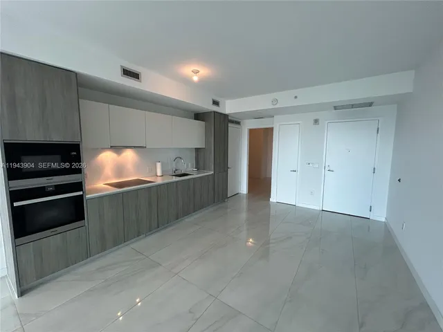 a kitchen with cabinets and oven