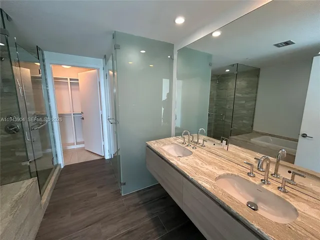 a bathroom with a double vanity sink and a mirror