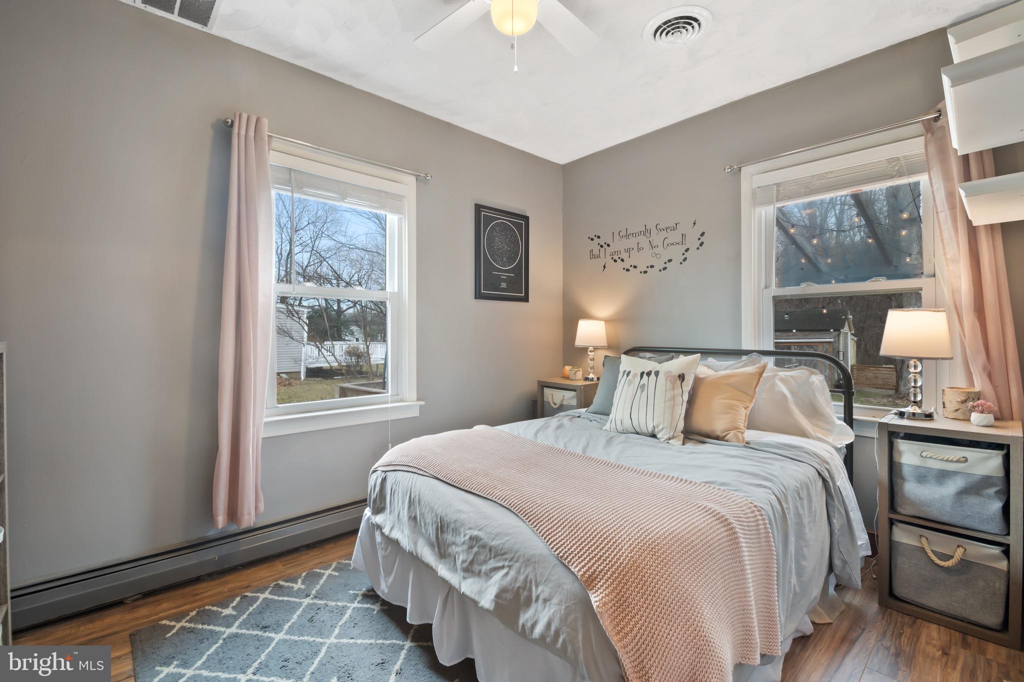 10520 Scaggsville Road Laurel, MD 20723 - Photo 17 of 32 a bedroom with a bed wooden floor and a window