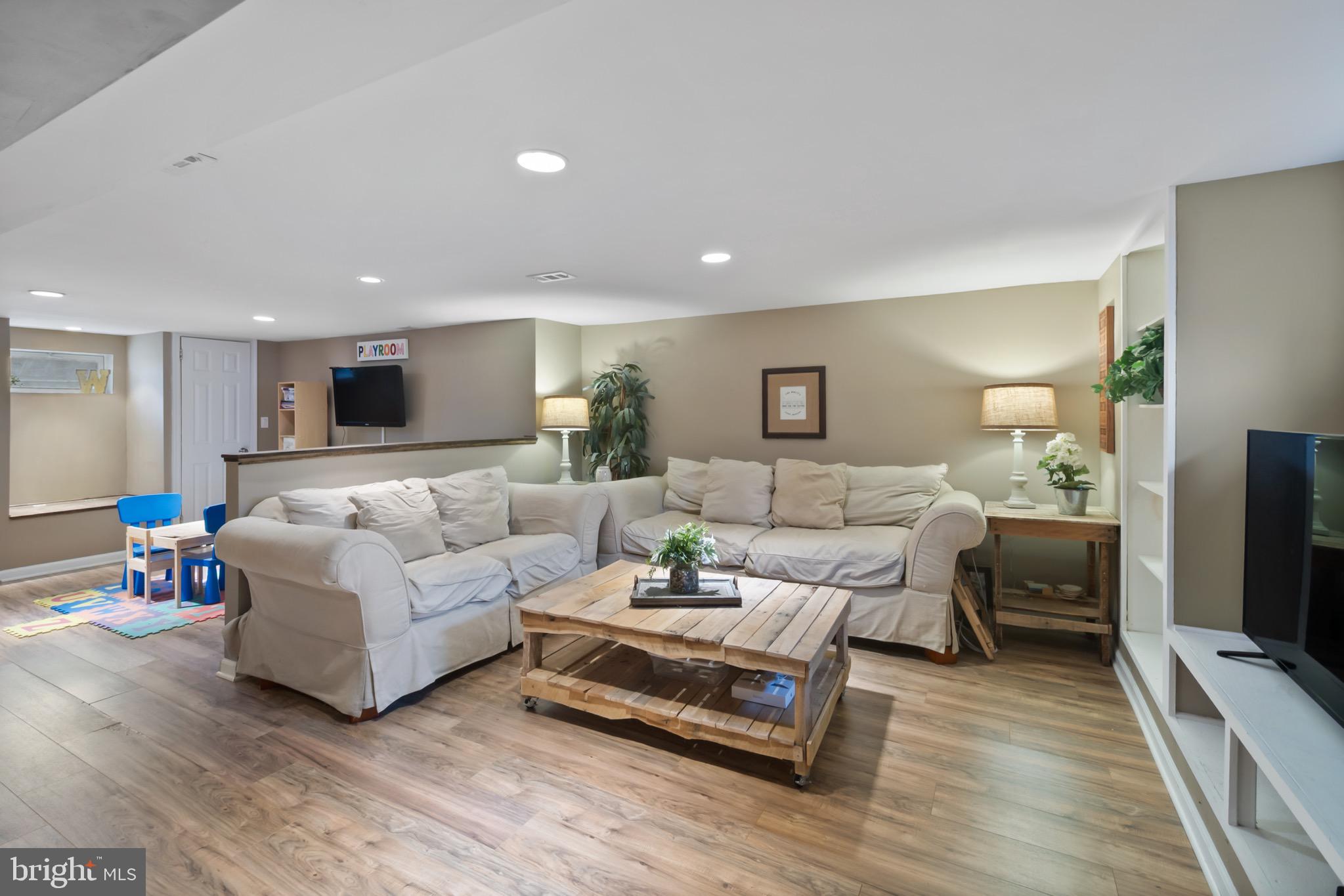 10520 Scaggsville Road Laurel, MD 20723 - Photo 23 of 32 a living room with furniture and a flat screen tv
