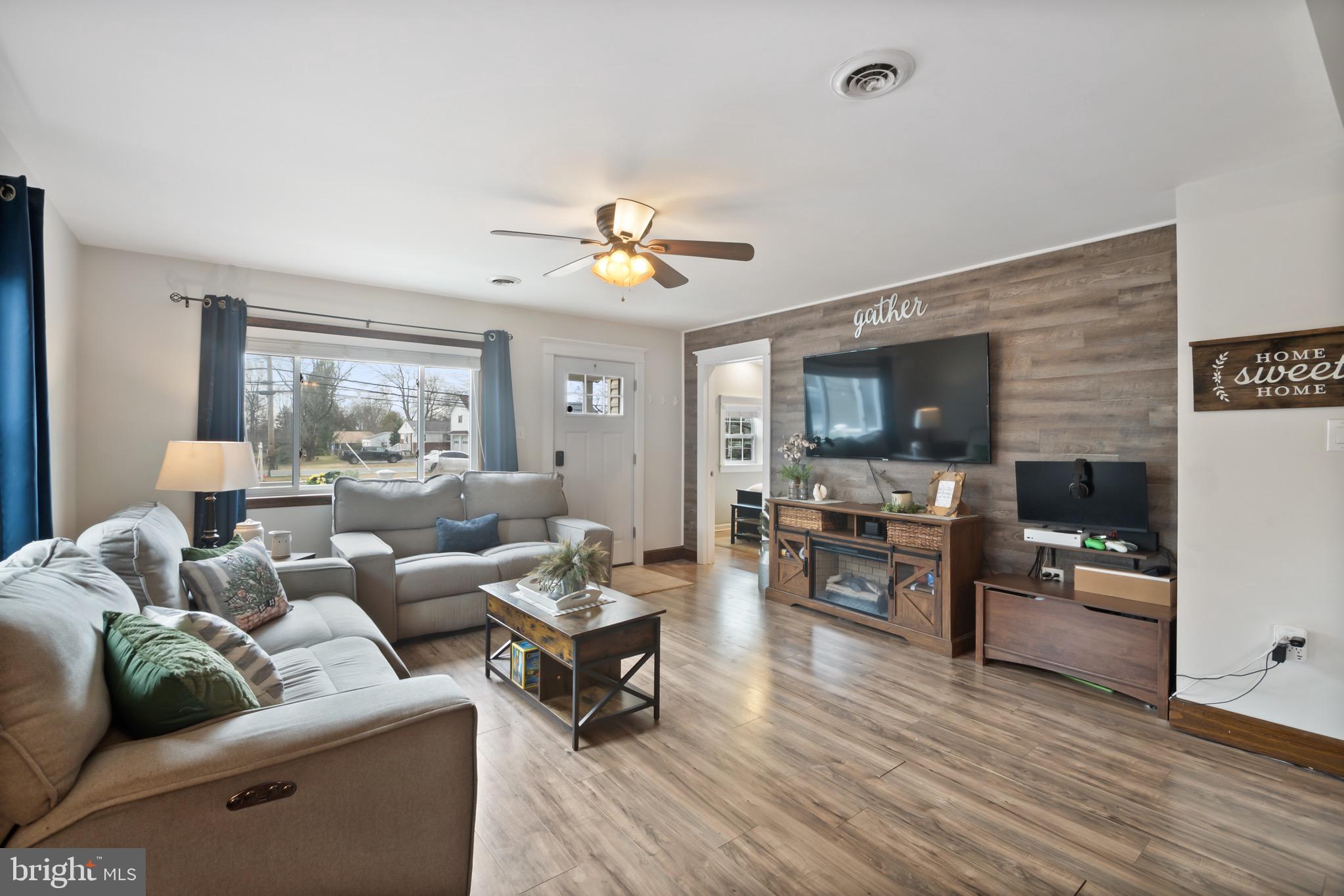 10520 Scaggsville Road Laurel, MD 20723 - Photo 6 of 32 a living room with furniture flat screen tv and wooden floor