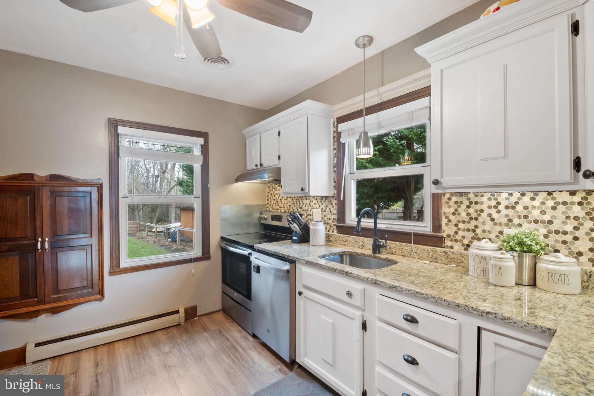 10520 Scaggsville Road Laurel, MD 20723 - Photo 9 of 32 a kitchen with granite countertop a sink stainless steel appliances and cabinets
