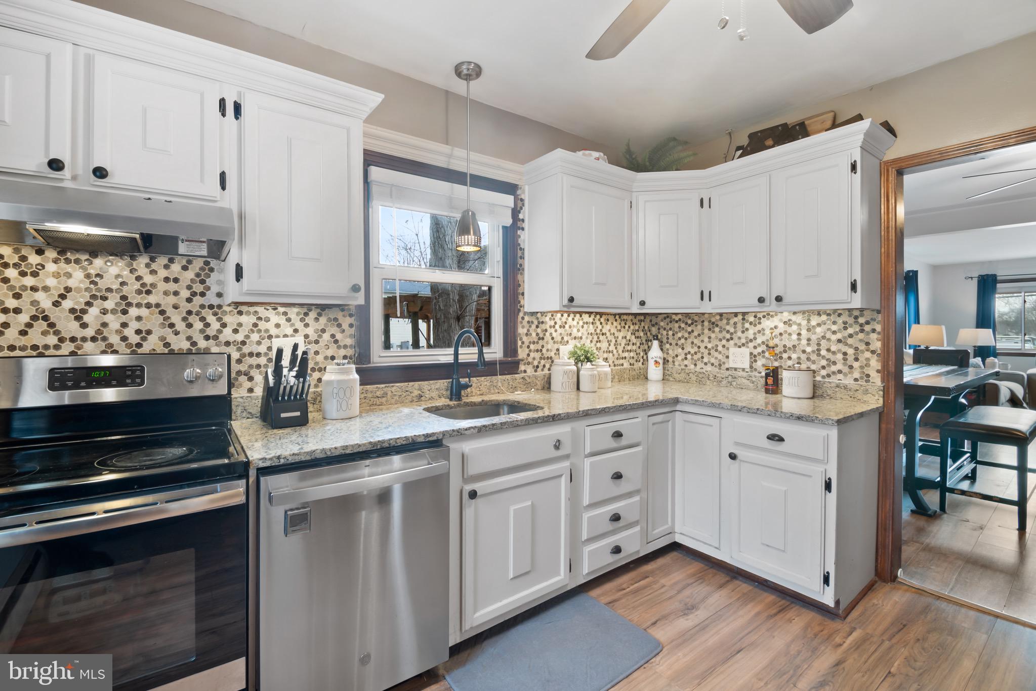 10520 Scaggsville Road Laurel, MD 20723 - Photo 10 of 32 a kitchen with granite countertop white cabinets and white appliances