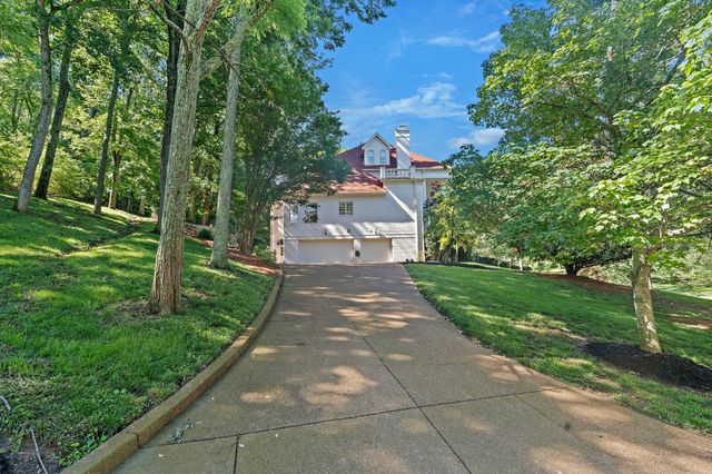 a bedroom with a bed a dresser and a window