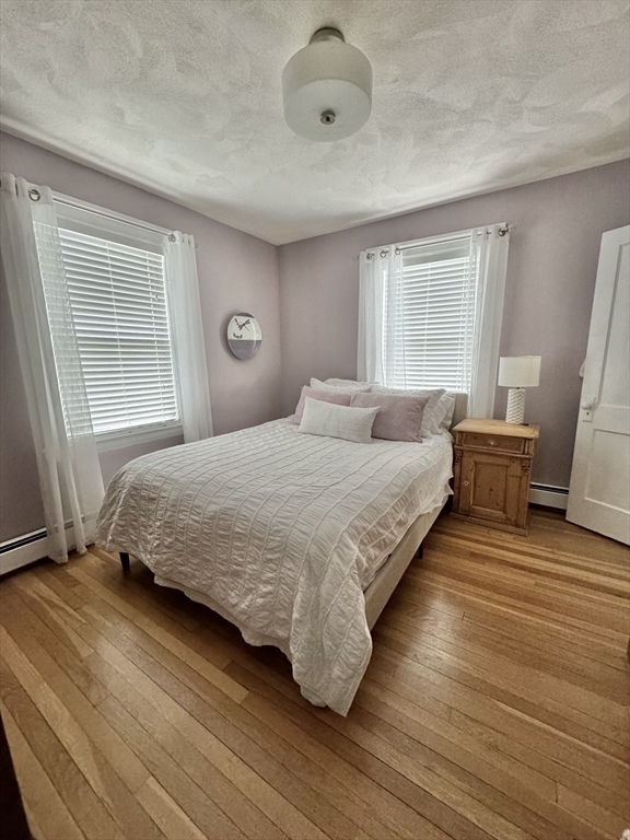 16 Evans Road Needham, MA 02492 - Photo 13 of 23 a bedroom with a bed and wooden floor