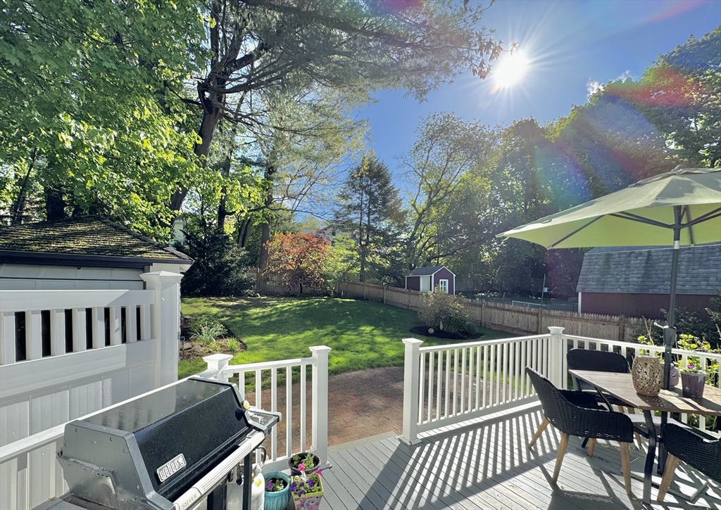 16 Evans Road Needham, MA 02492 - Photo 22 of 23 a view of a patio with a table chairs and a yard