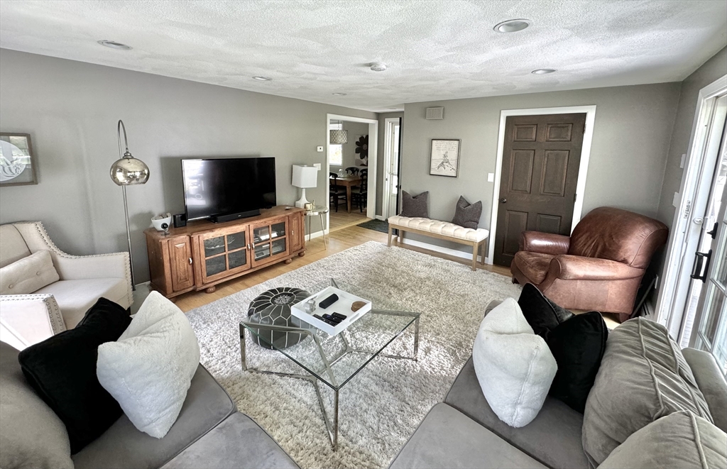 16 Evans Road Needham, MA 02492 - Photo 7 of 23 a living room with furniture and a flat screen tv