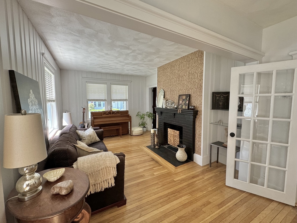 16 Evans Road Needham, MA 02492 - Photo 9 of 23 a living room with furniture and a fireplace