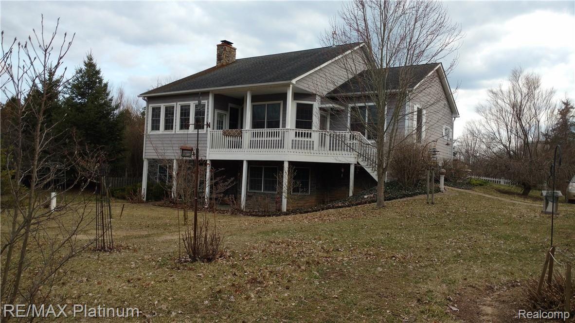 4692 Vines Road Howell, MI 48843 - Photo 2 of 32 Walk out with covered deck and patio.