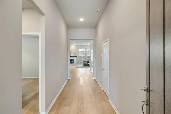 a view of hallway with wooden floor