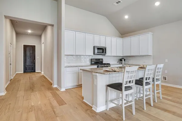 a kitchen with a sink a microwave and refrigerator