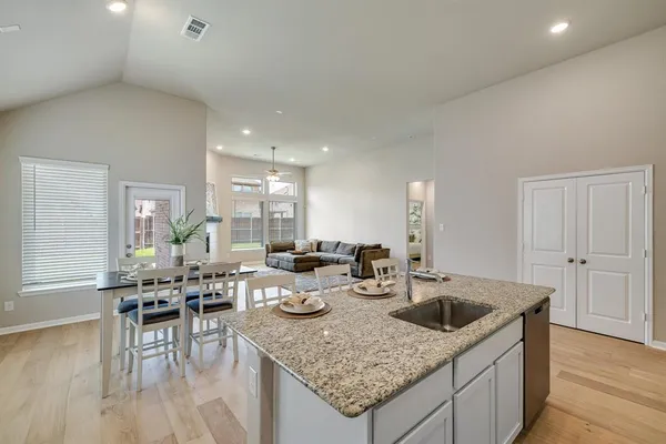 a kitchen with granite countertop lots of counter top space and furniture