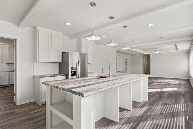 a kitchen with stainless steel appliances kitchen island a chandelier