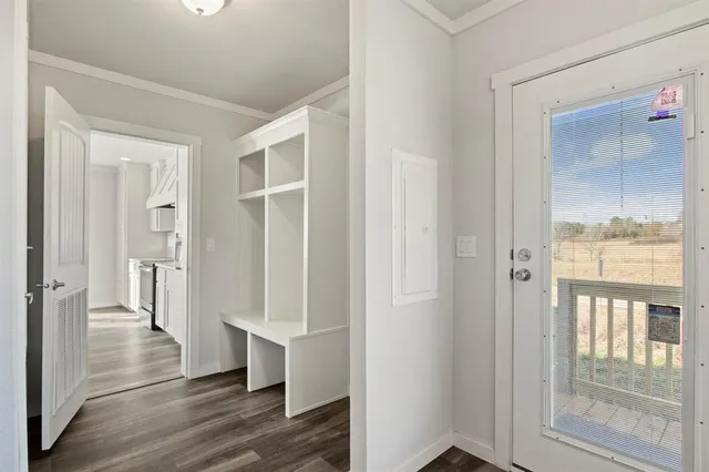 a view of a hallway with wooden floor and glass door