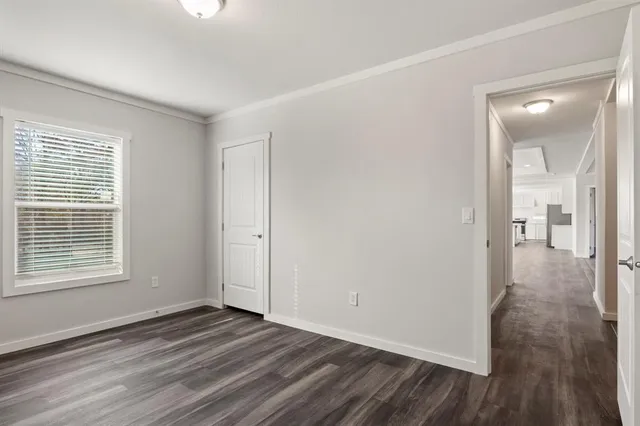 a bathroom with a granite countertop sink a toilet and a mirror