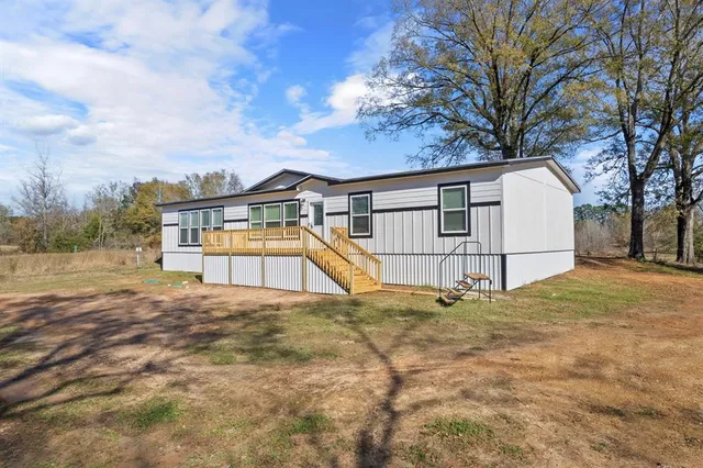 a view of a house with a yard and fence