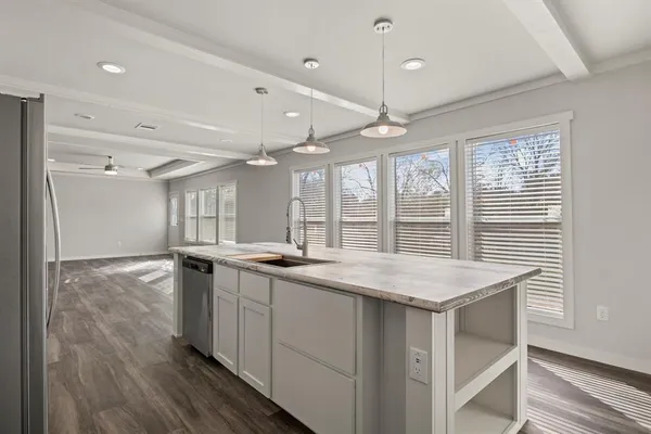 a kitchen with stainless steel appliances granite countertop a stove and a wooden floors