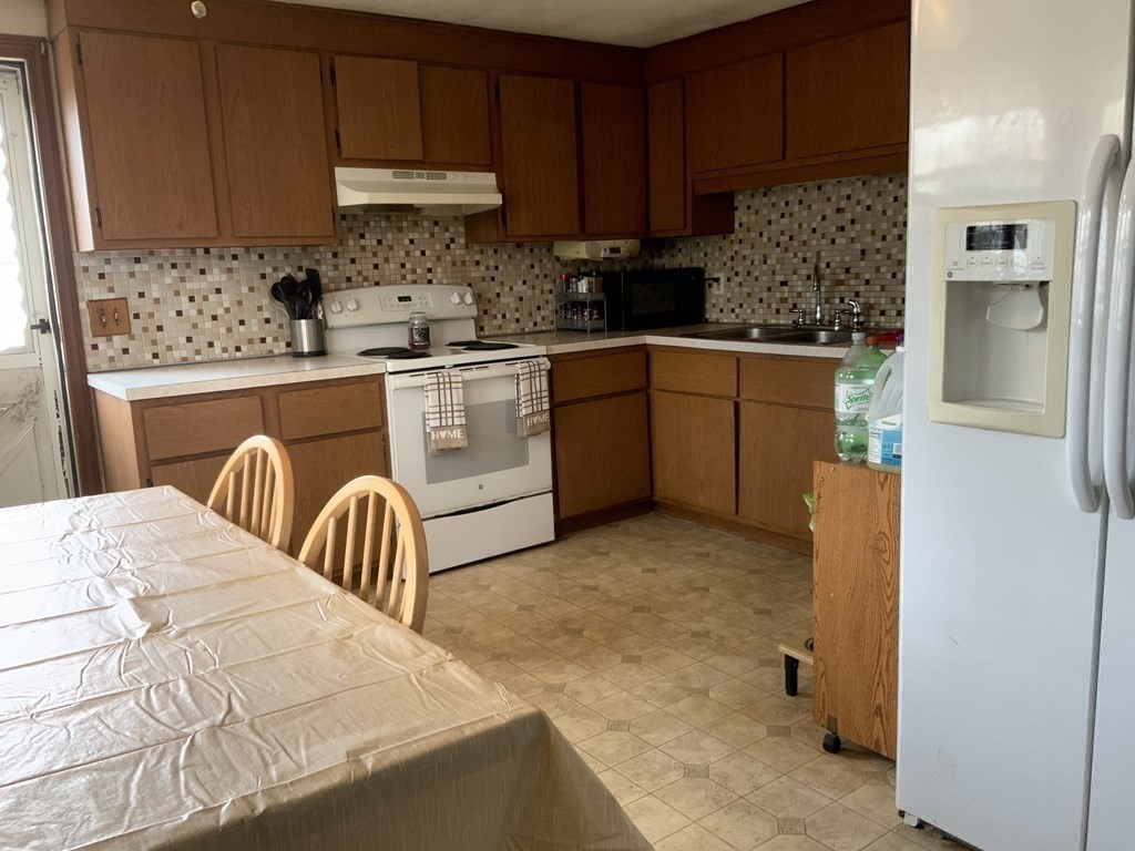 44-46 Catalina Road Lynn, MA 01905 - Photo 21 of 28 a kitchen with granite countertop a sink a stove and cabinets