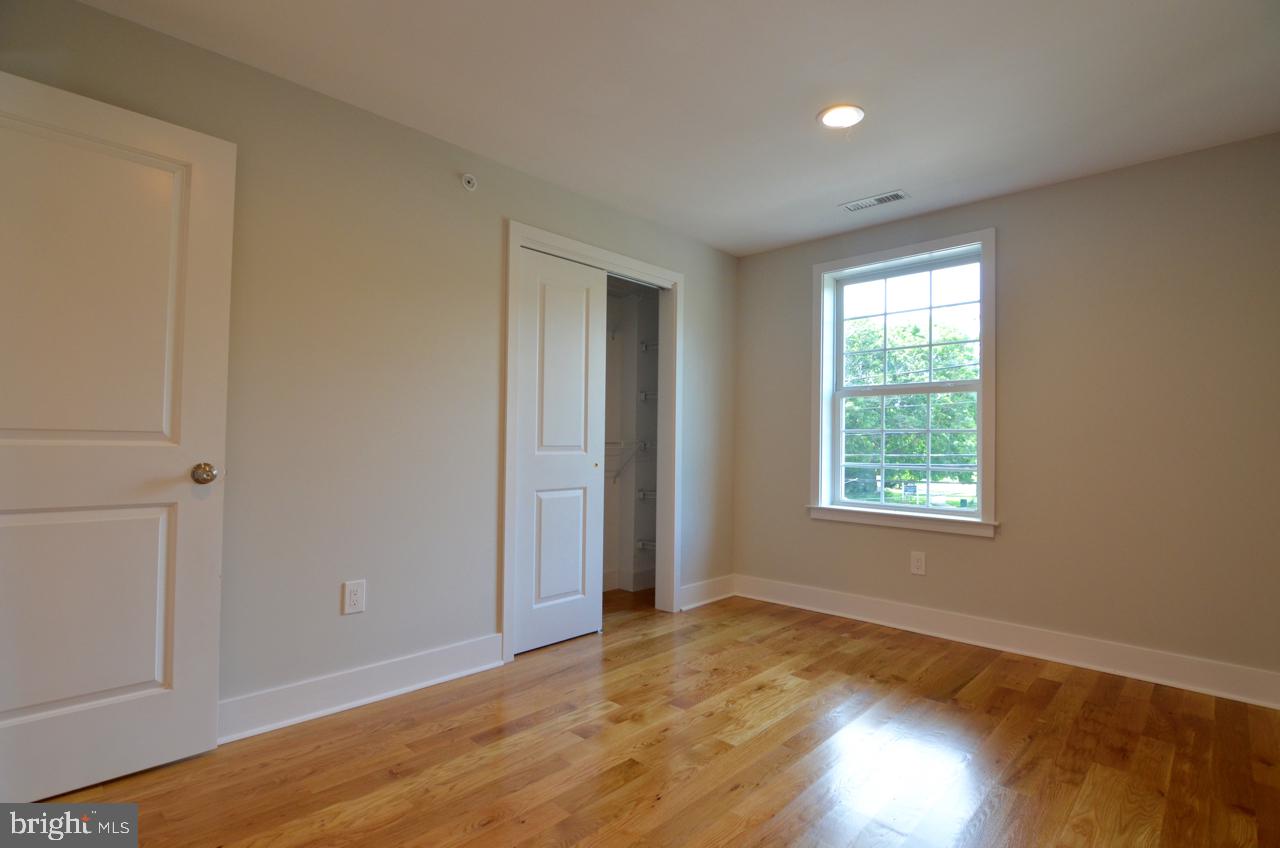 400 West Wayne Avenue, Unit 3 Wayne, PA 19087 - Photo 9 of 14 a view of an empty room with wooden floor and a window