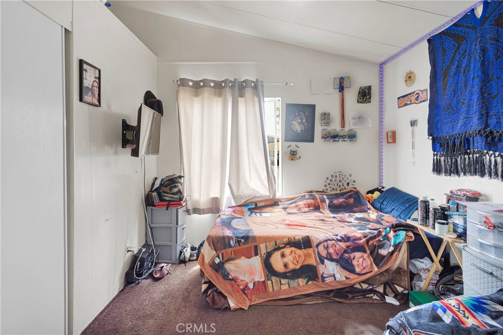 2494 Main Street, Unit 112 Barstow, CA 92311 - Photo 15 of 20 a bedroom with a bed a couch and dresser