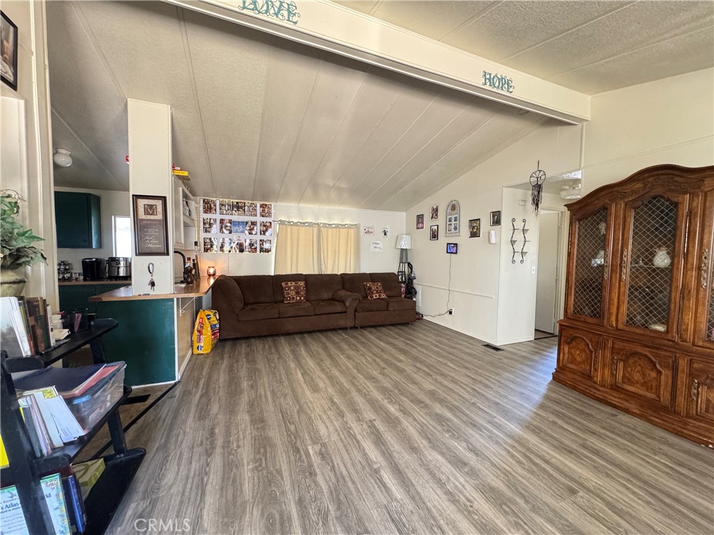 2494 Main Street, Unit 112 Barstow, CA 92311 - Photo 4 of 20 a living room with furniture and a wooden floor