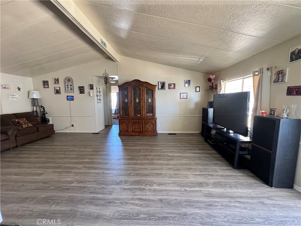 2494 Main Street, Unit 112 Barstow, CA 92311 - Photo 6 of 20 a living room with furniture and a flat screen tv