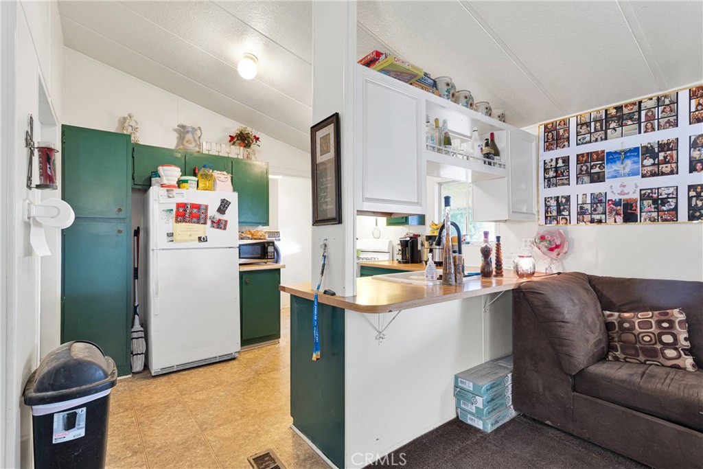 2494 Main Street, Unit 112 Barstow, CA 92311 - Photo 7 of 20 a living room with furniture and a dining table