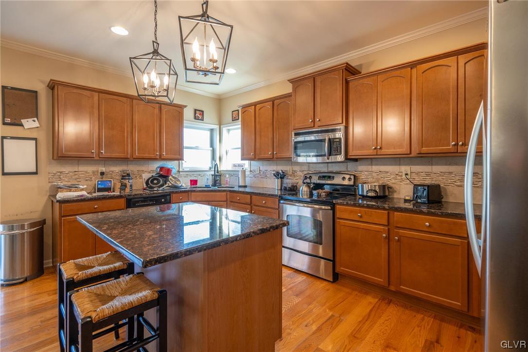 1240 Miller Road Wind Gap, PA 18091 - Photo 18 of 48 a kitchen with stainless steel appliances granite countertop a sink dishwasher stove refrigerator and microwave