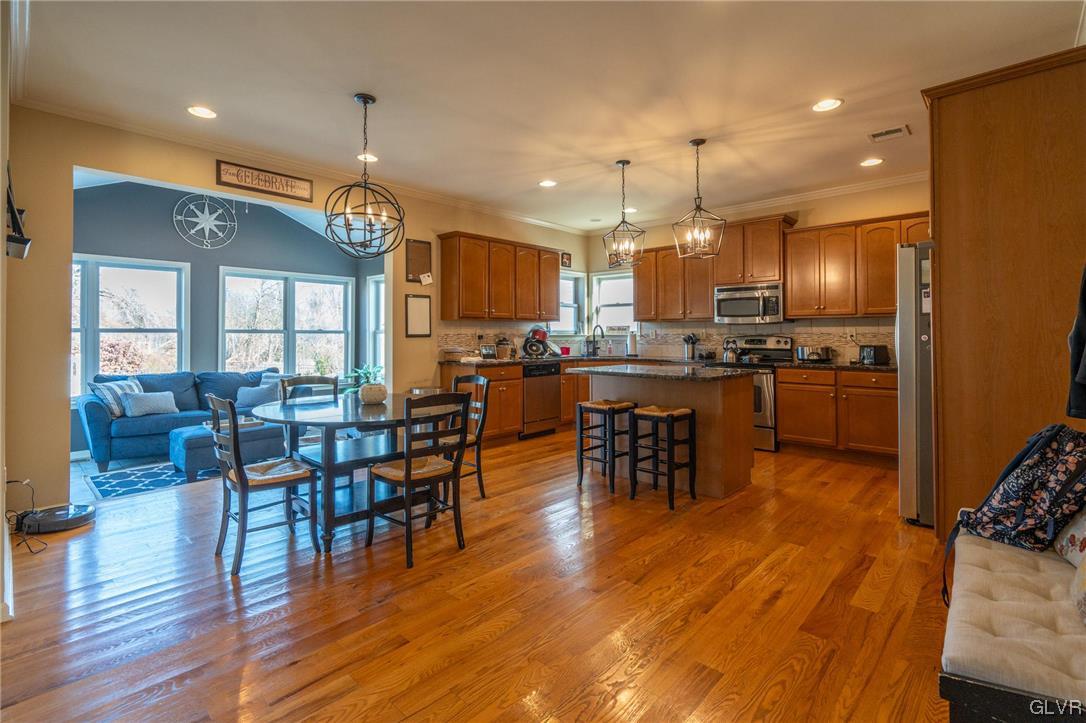 1240 Miller Road Wind Gap, PA 18091 - Photo 20 of 48 a kitchen with stainless steel appliances a dining table chairs stove and wooden floor