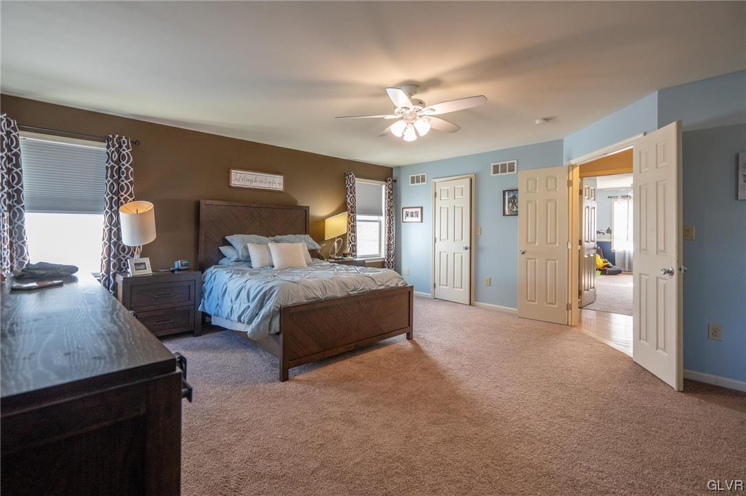 1240 Miller Road Wind Gap, PA 18091 - Photo 27 of 48 a spacious bedroom with a bed and a chandelier