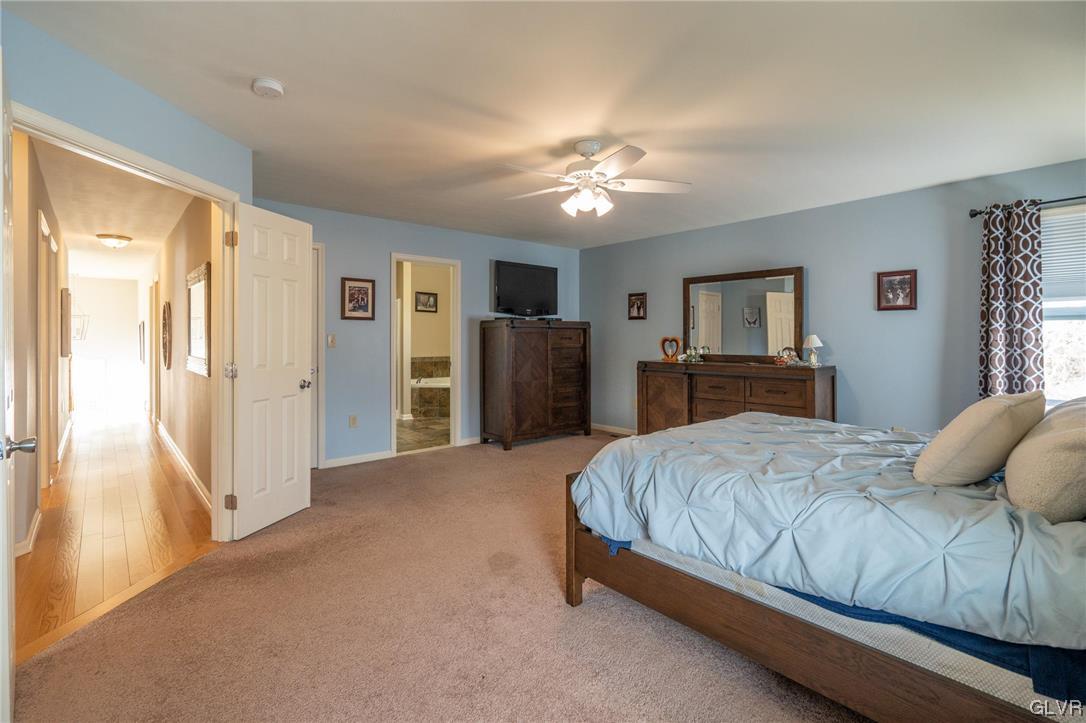 1240 Miller Road Wind Gap, PA 18091 - Photo 29 of 48 a bedroom with a large bed closet and flat tv screen