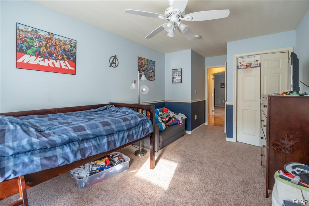 1240 Miller Road Wind Gap, PA 18091 - Photo 34 of 48 a bedroom with bed and a chandelier