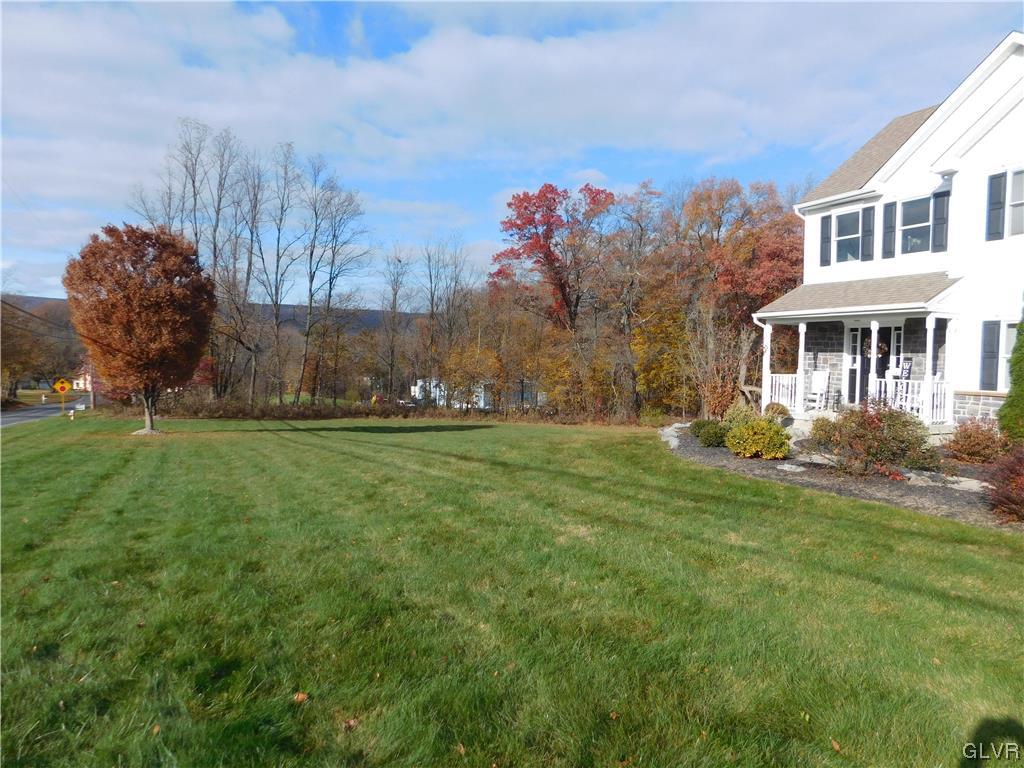 1240 Miller Road Wind Gap, PA 18091 - Photo 7 of 48 a front view of a house with a yard and trees