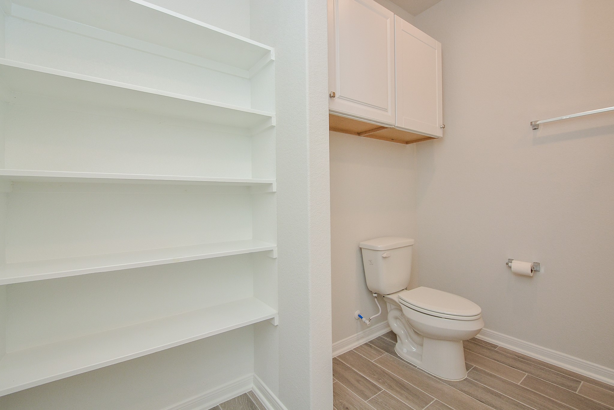 8634 Herring Lane Cypress, TX 77433 - Photo 12 of 50 a bathroom with a toilet and a view