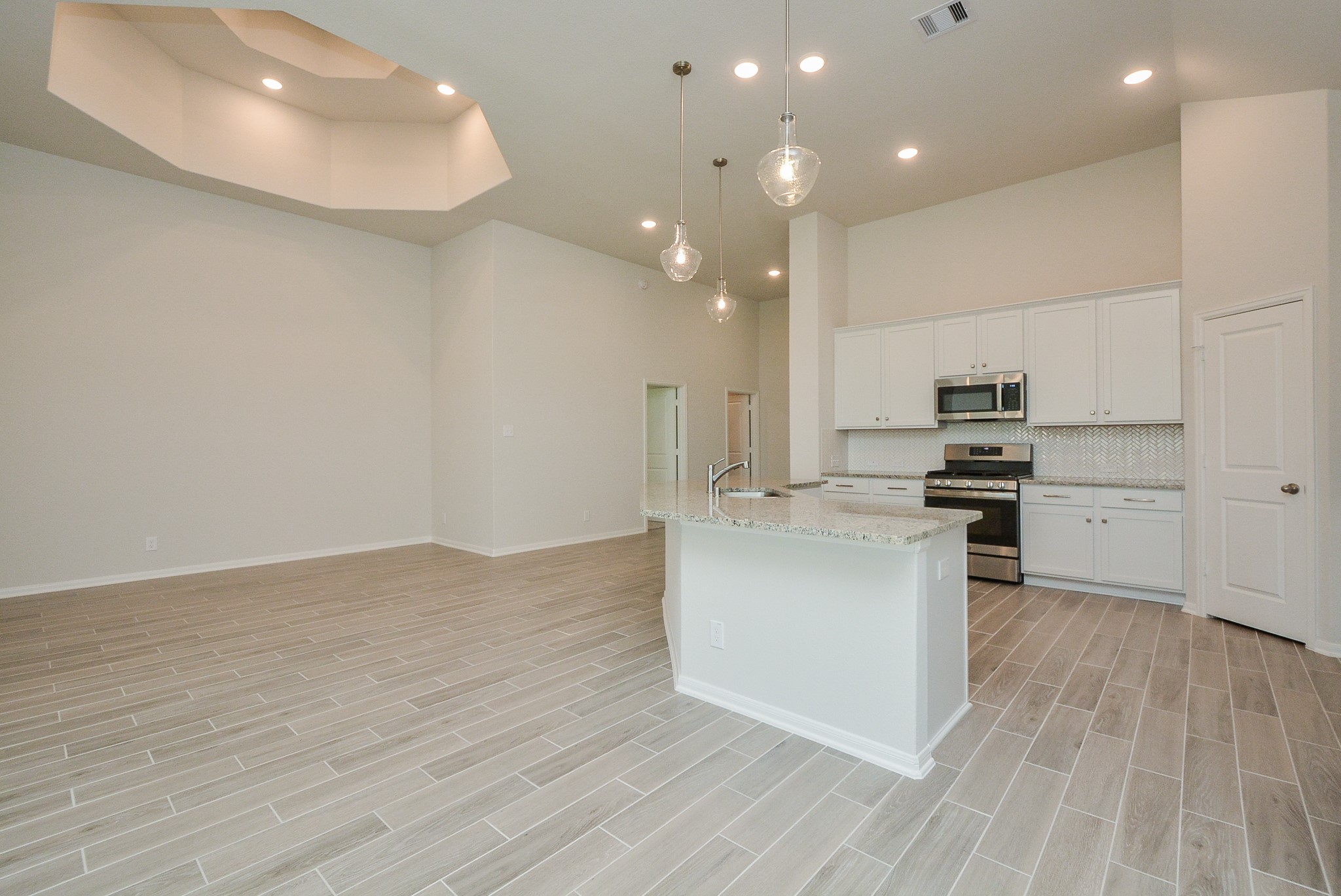 8634 Herring Lane Cypress, TX 77433 - Photo 22 of 50 a kitchen with stainless steel appliances a refrigerator and a stove top oven