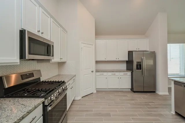 a kitchen with a stove microwave and refrigerator